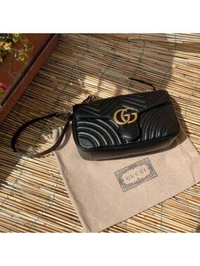 BlackGucci GG Marmont quilted black leather flap bag Gucci Marmont flap bag